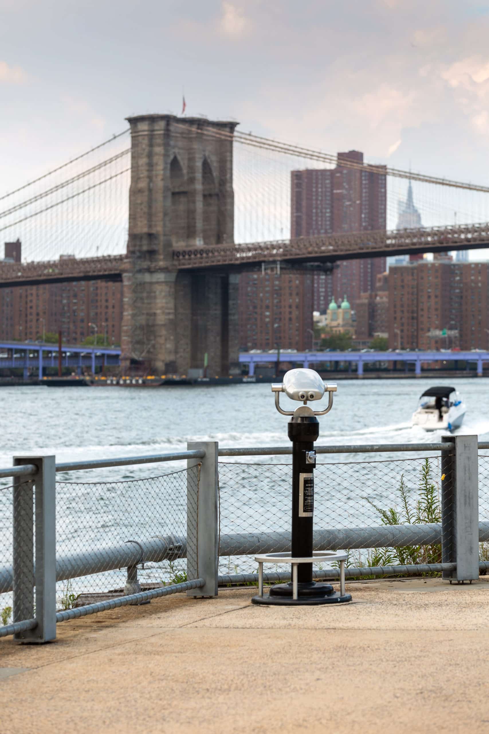 Public binoculars on Pier 1 facing the Brooklyn Bridge and lower Manhattan.
