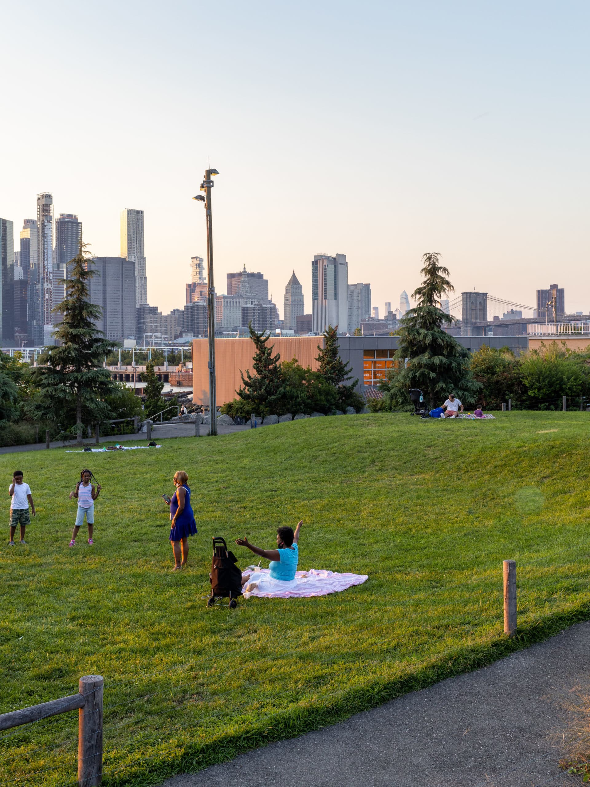 People picnicking on Pier 5 Uplands Lawn at sunset.