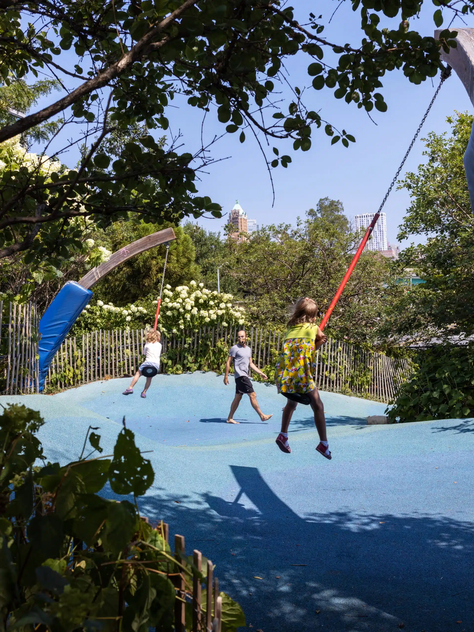 Children swinging on rope swings at Swing Valley at Pier 6 on a sunny day.