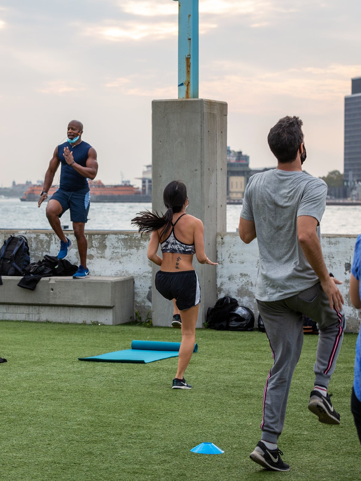 Close up of instructor and people jumping on Pier 2 Play Turf.