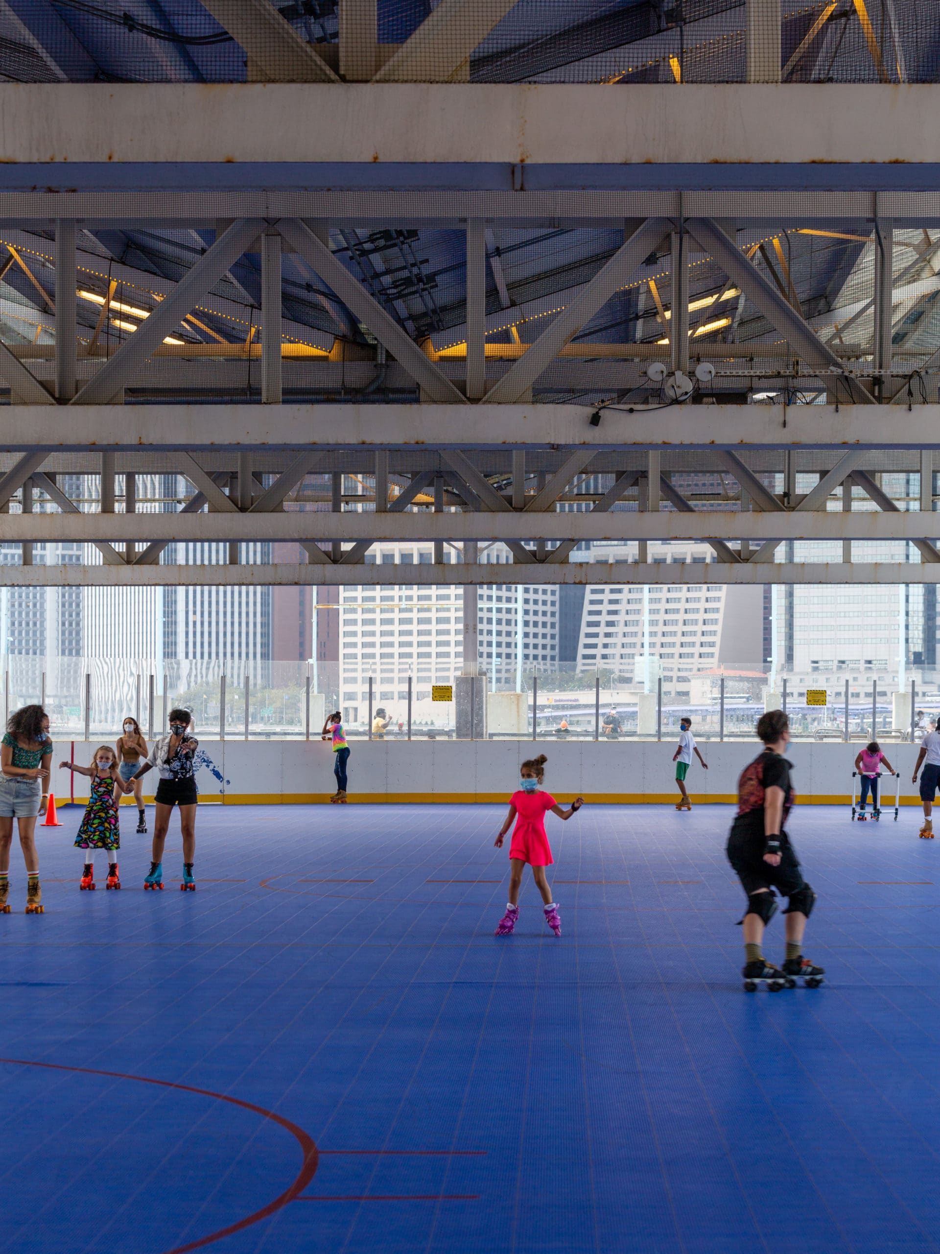 People skating at the rink under the roof at Pier 2.