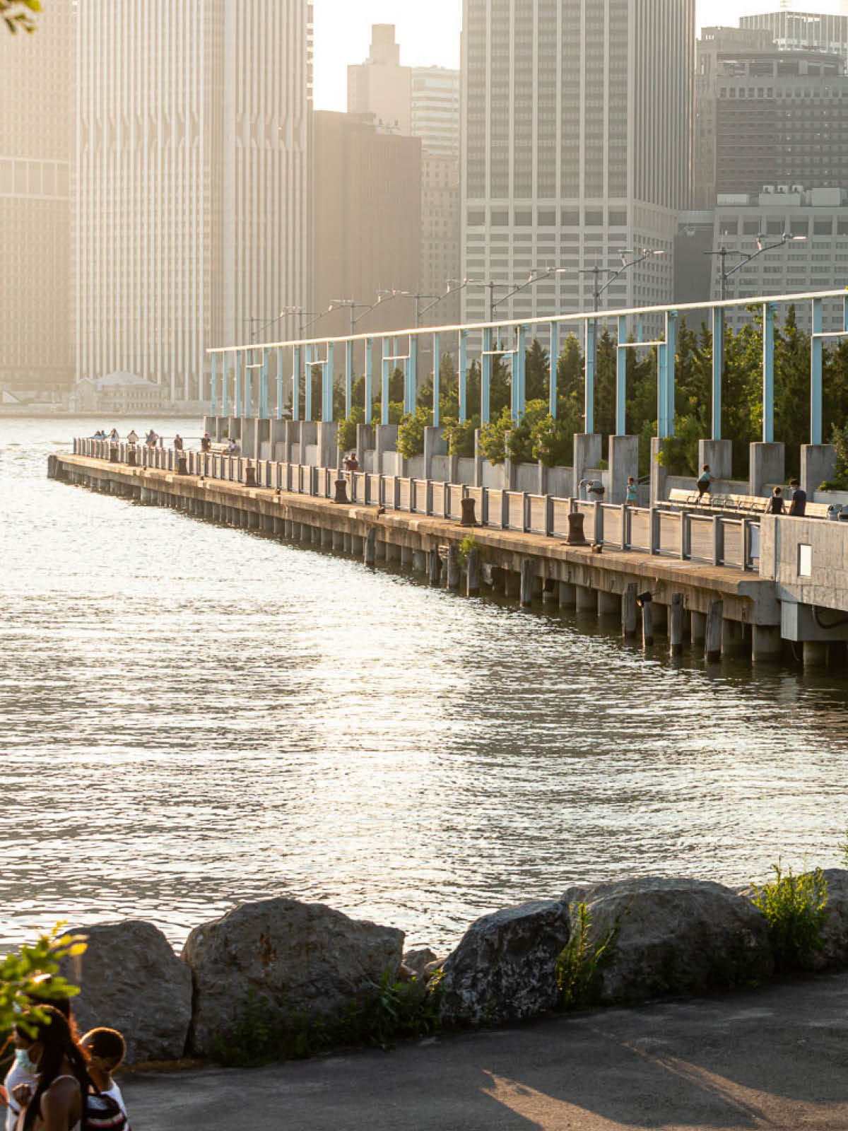 View of Pier 3 from the Greenway at sunset. Lower Manhattan is seen in the background.