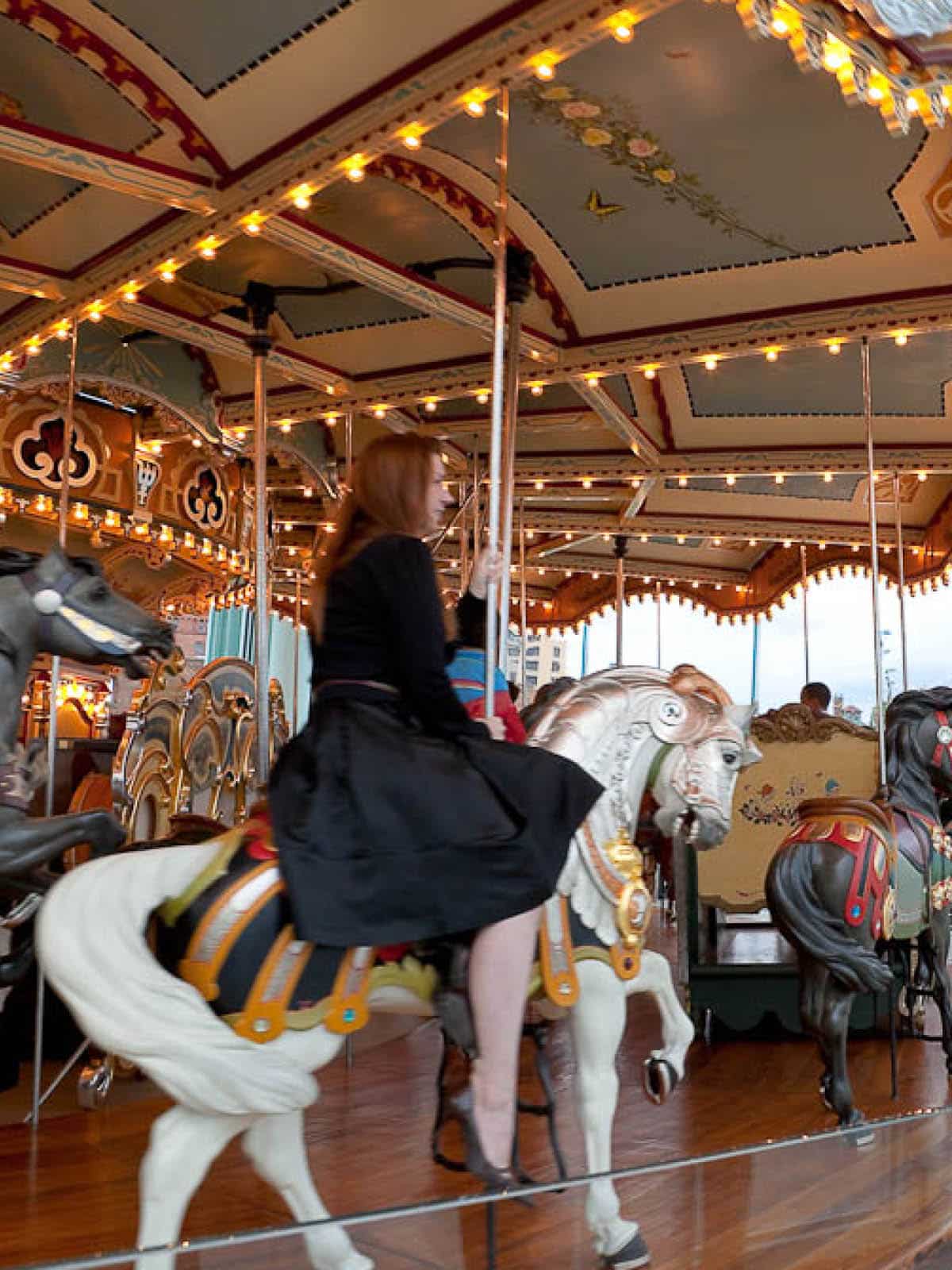 Woman sitting on carousel horse on Jane's Carousel.